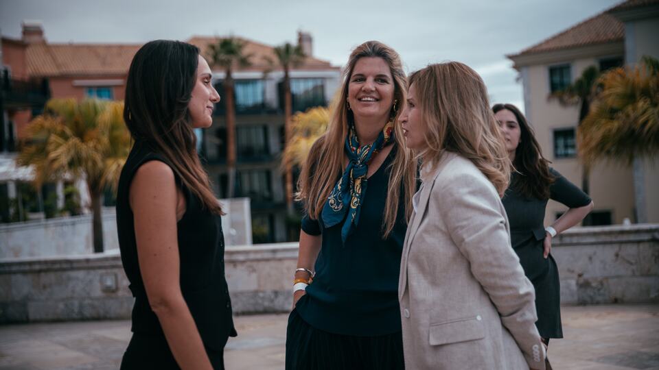 Three women networking outdoors during the PREIS reception