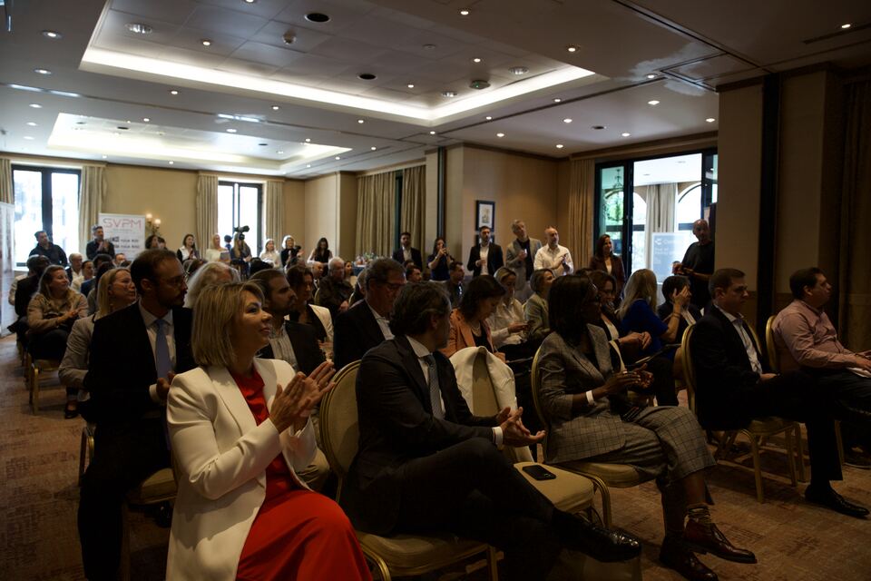 The seated PREIS audience applauding during the conference
