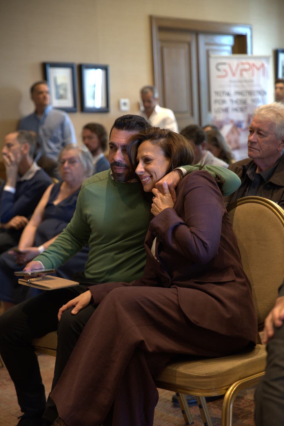 Two seated PREIS guests sharing a warm moment in the audience