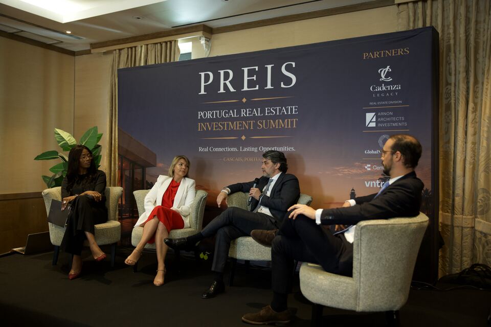 Four speakers exchanging views during a PREIS panel session