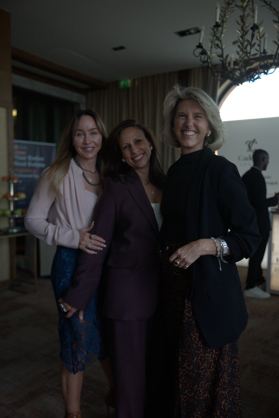 Three women posing together during the PREIS reception